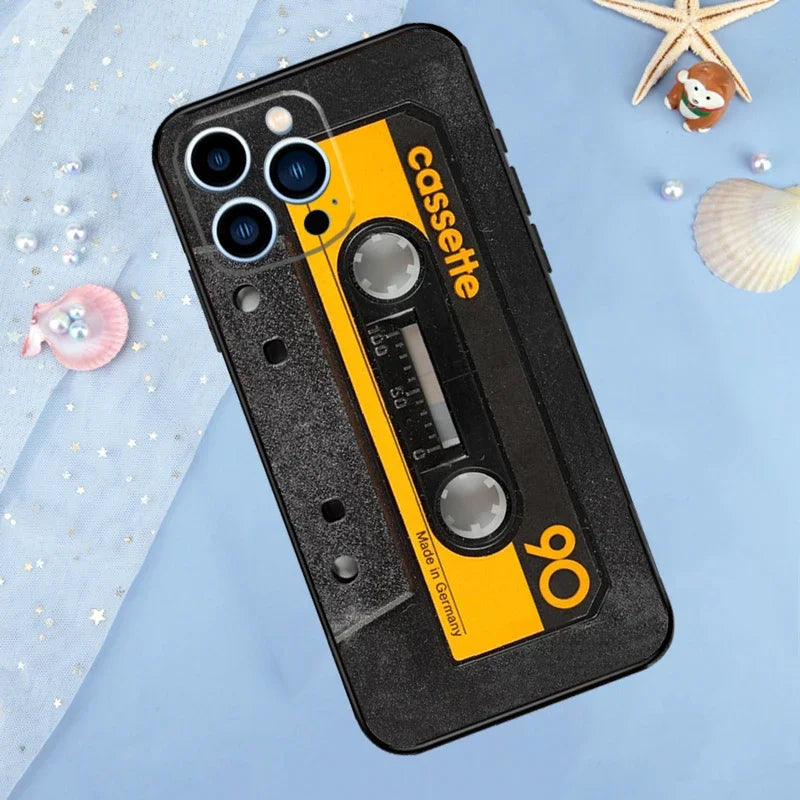 A black phone case designed to look like a vintage cassette tape with a yellow label and a tape reel visible.