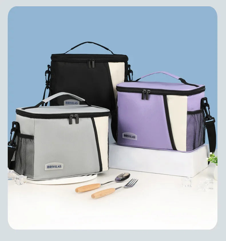 Three insulated reusable lunch bags in black, purple, and gray with white accents are displayed on a white surface.