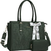 A dark green PU leather laptop tote bag with a floral scarf tied on the handle and a matching clutch.