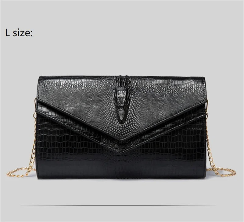Black alligator pattern leather clutch bag displayed flat on a light gray background.