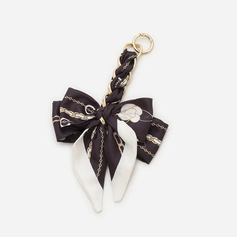 Black and white patterned adjustable bag strap with gold hardware