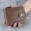 A brown leather horizontal zipper card wallet is held in a hand against a gray background.