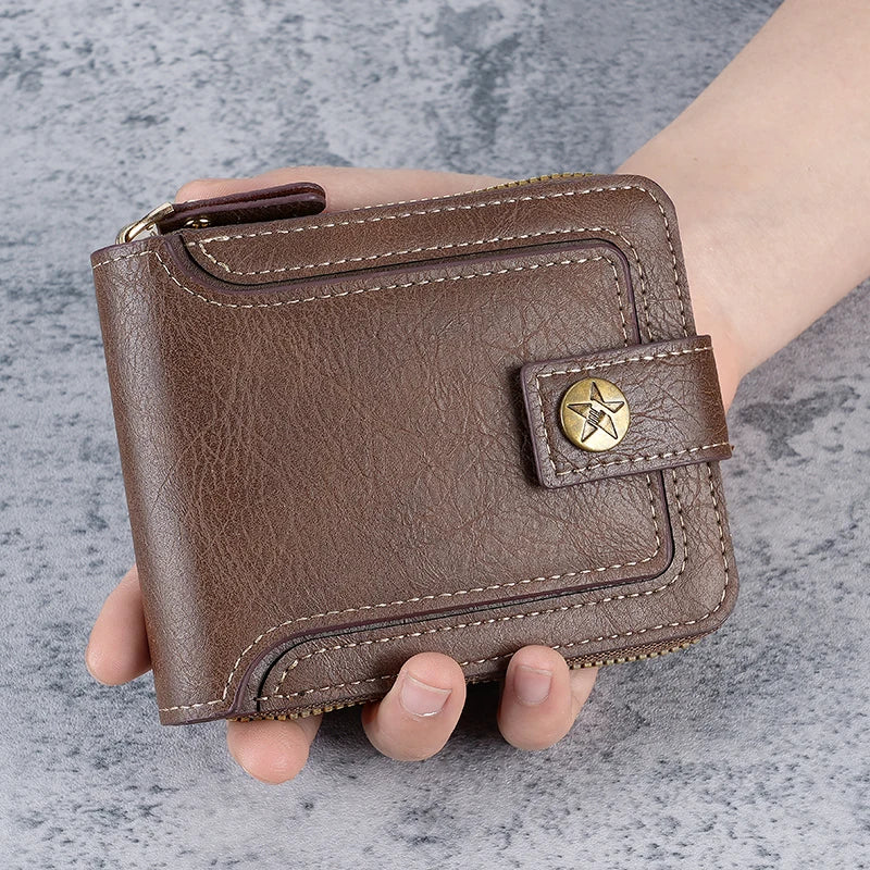 A brown leather horizontal zipper card wallet is held in a hand against a gray background.