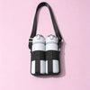 A black crossbody sling water bottle bag with white and black striped bottles.