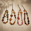 Four vintage beaded charm necklaces displayed on a neutral background with soft shadows.