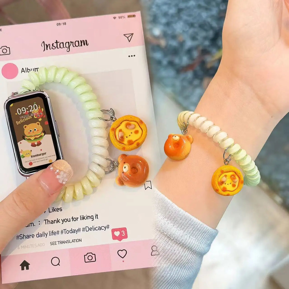A hand is wearing a light green elastic watch strap with a gold charm on a wrist, next to an Instagram screen.