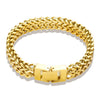 A thick gold link chain bracelet worn on a wrist.