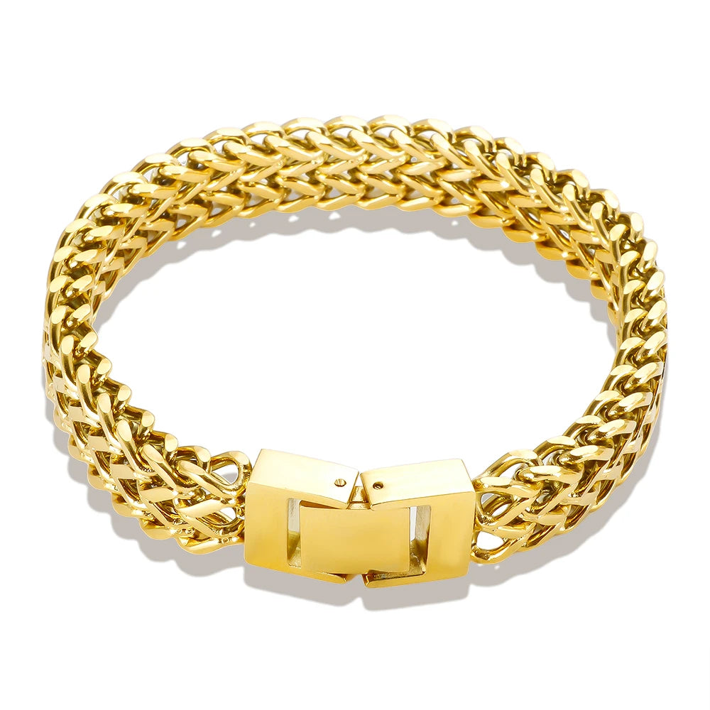 A thick gold link chain bracelet worn on a wrist.
