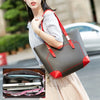 A woman holds a gray tote bag with red accents, next to an open organizer showing various cosmetic and essential items.