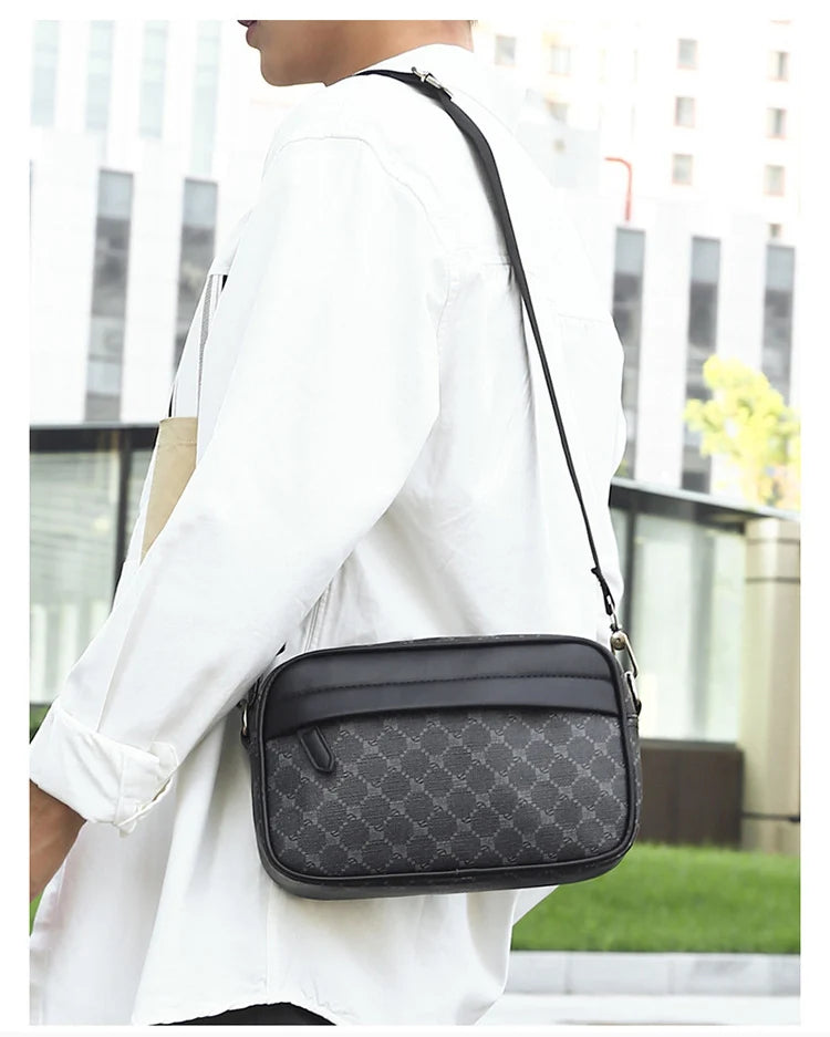 A man wearing a white shirt carries a black PU leather shoulder clutch bag.