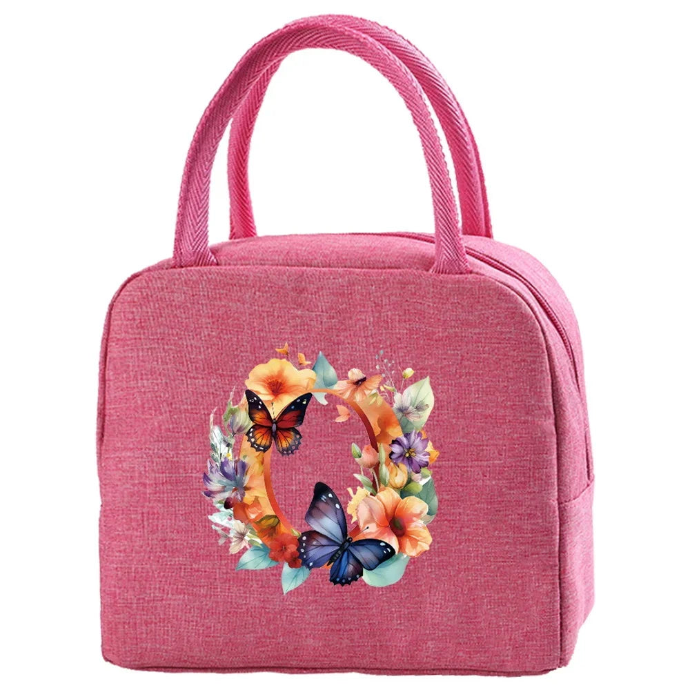 A pink insulated canvas lunch bag featuring a floral wreath design.