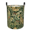A vintage floral laundry hamper with a dark green fabric featuring intricate patterns and black handles.