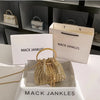 A gold crystal-embellished evening clutch with a chain displayed in a white box.