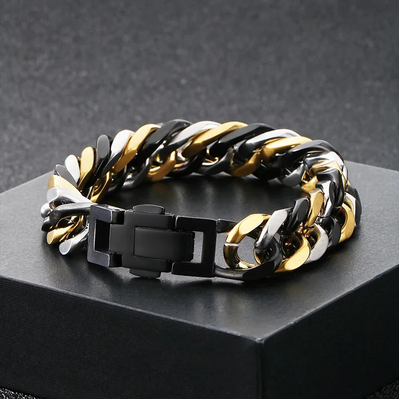 A chunky Cuban link bracelet featuring alternating black and gold links displayed on a dark surface.