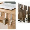 A heavy duty multi-purpose hook rack with hangers is installed on a wooden cabinet door, next to a laptop.