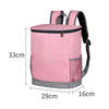 Pink insulated cooler backpack with gray accents and black straps, shown with dimensions.
