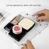 A hand is opening a transparent portable organizer pouch for cosmetics and tools, showing various items inside.