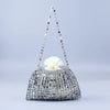 A handmade silver and gold beaded dumpling bag with a white flower decoration.