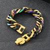 A chunky gold and black Cuban link bracelet with iridescent accents shown on a dark surface.