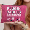 A pink zippered pouch filled with various plugs, cables, and chargers is held by a person.