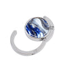 Silver folding table bag hook with a round glass featuring blue and white marble patterns