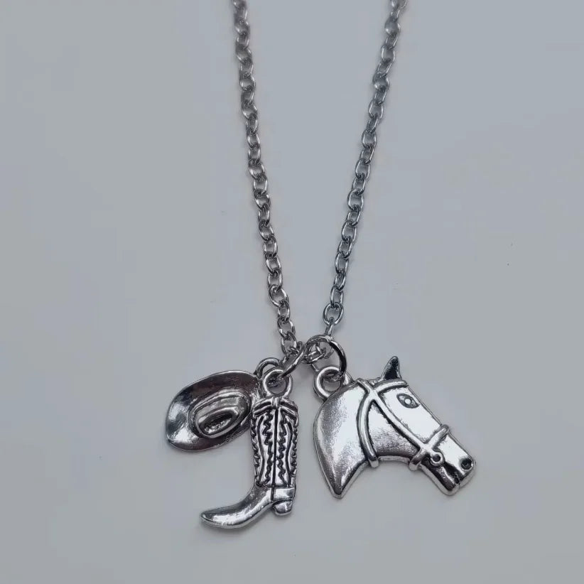 Silver necklace featuring a western cowboy boot and hat horseshoe keychain set