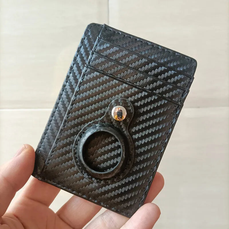 A close-up of a black woven texture RFID blocking card holder wallet being held by a hand.