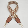 A beige and brown checkered braided nylon bag strap with metal hooks.