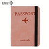 A pink leather passport holder with a black stripe and a stylized airplane design.