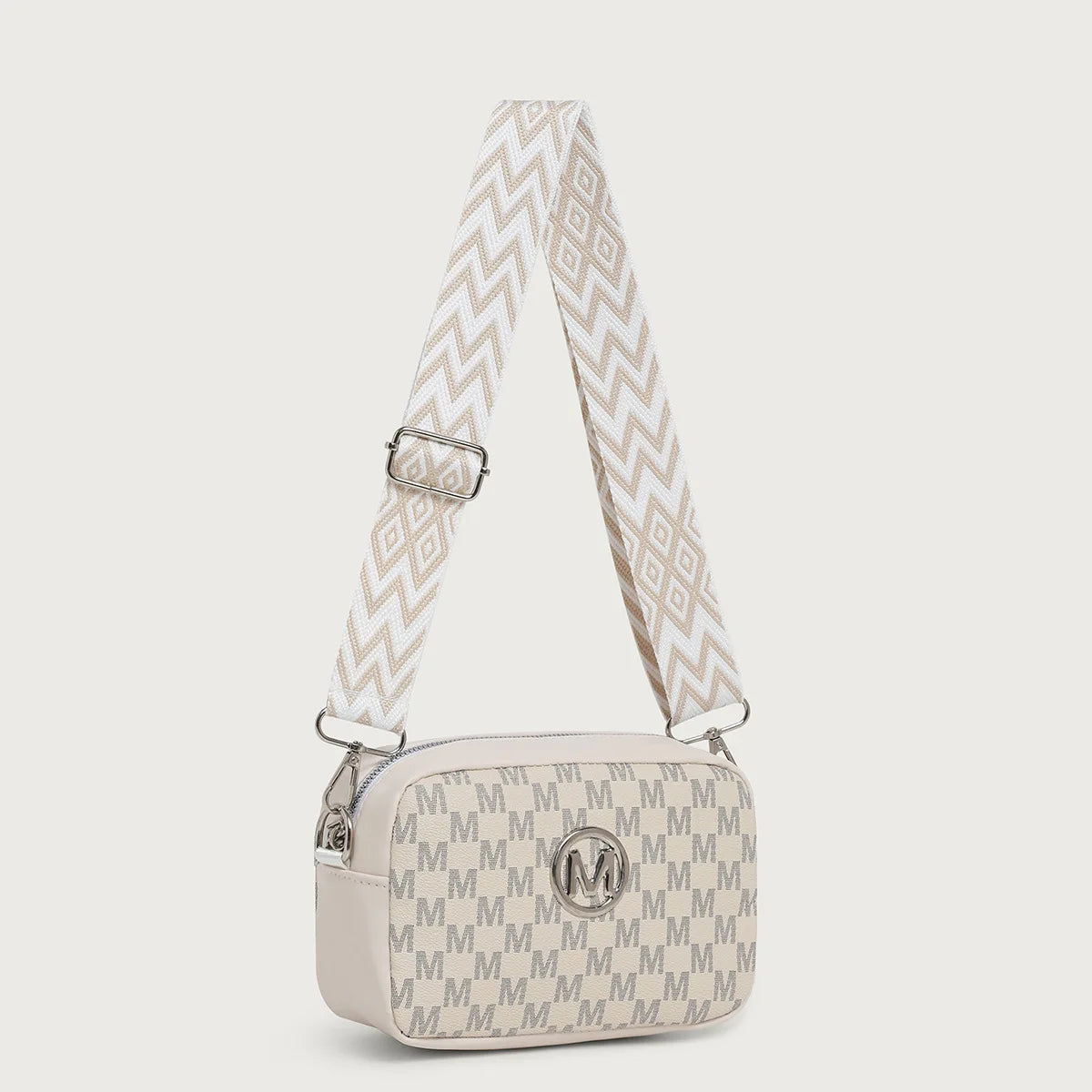 A beige patterned crossbody bag featuring a chevron print and a smooth leather strap.