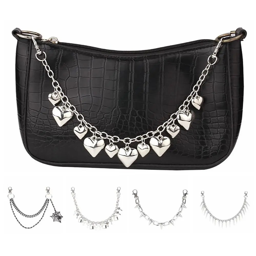 Black crocodile print purse with a silver chain strap and multiple heart-shaped charms