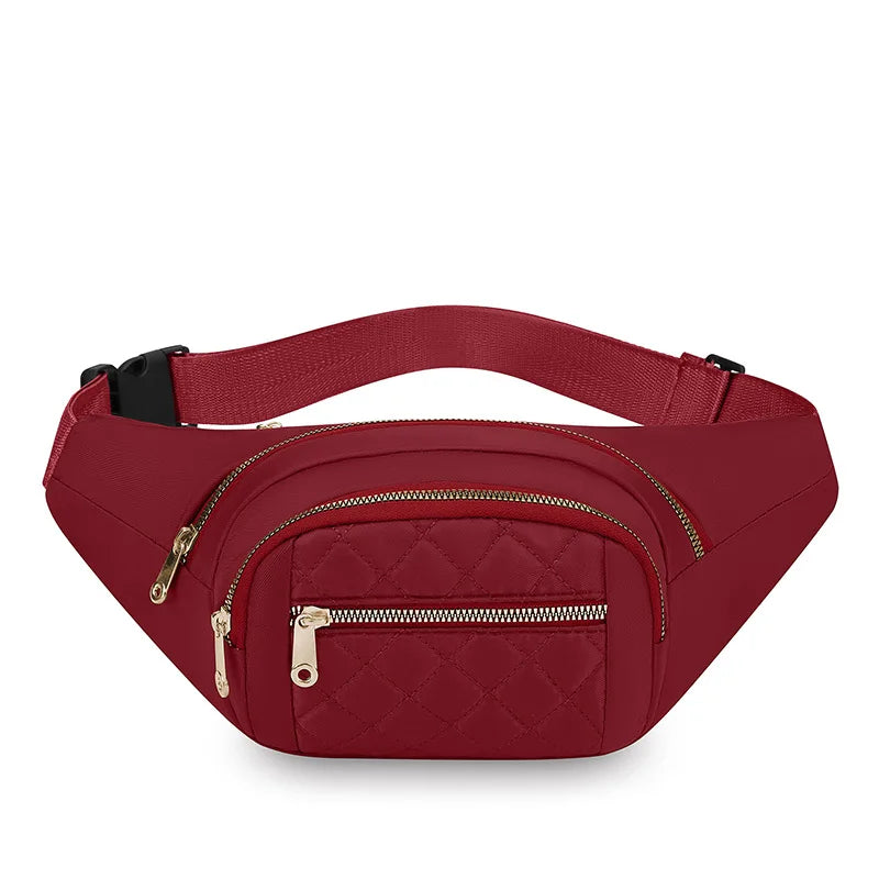 A maroon quilted nylon crossbody belt bag with a gold zipper and black strap.