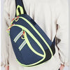 A person is wearing a navy blue medical crossbody bag with lime green accents over a light beige shirt.