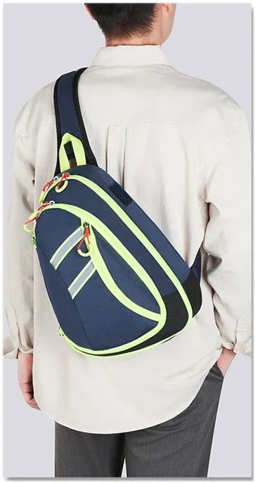 A person is wearing a navy blue medical crossbody bag with lime green accents over a light beige shirt.