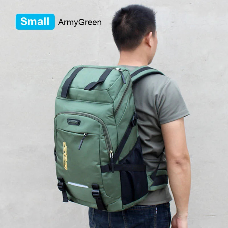 A person is shown wearing a small ArmyGreen backpack with a rain cover on a light gray background.
