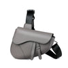 A gray men's solid color chest bag with a black strap is shown from the side.