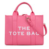Sac cabas de luxe rose, marque, avec une sangle en cuir et des éléments dorés.