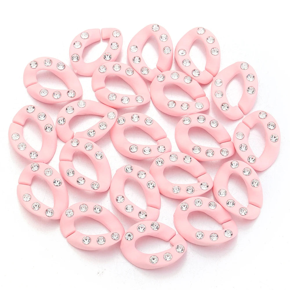 A collection of pink acrylic link chain connectors with clear rhinestones for DIY jewelry making