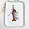 A detailed simulation fish keychain featuring iridescent scales, purple accents, and a gold-colored hook.