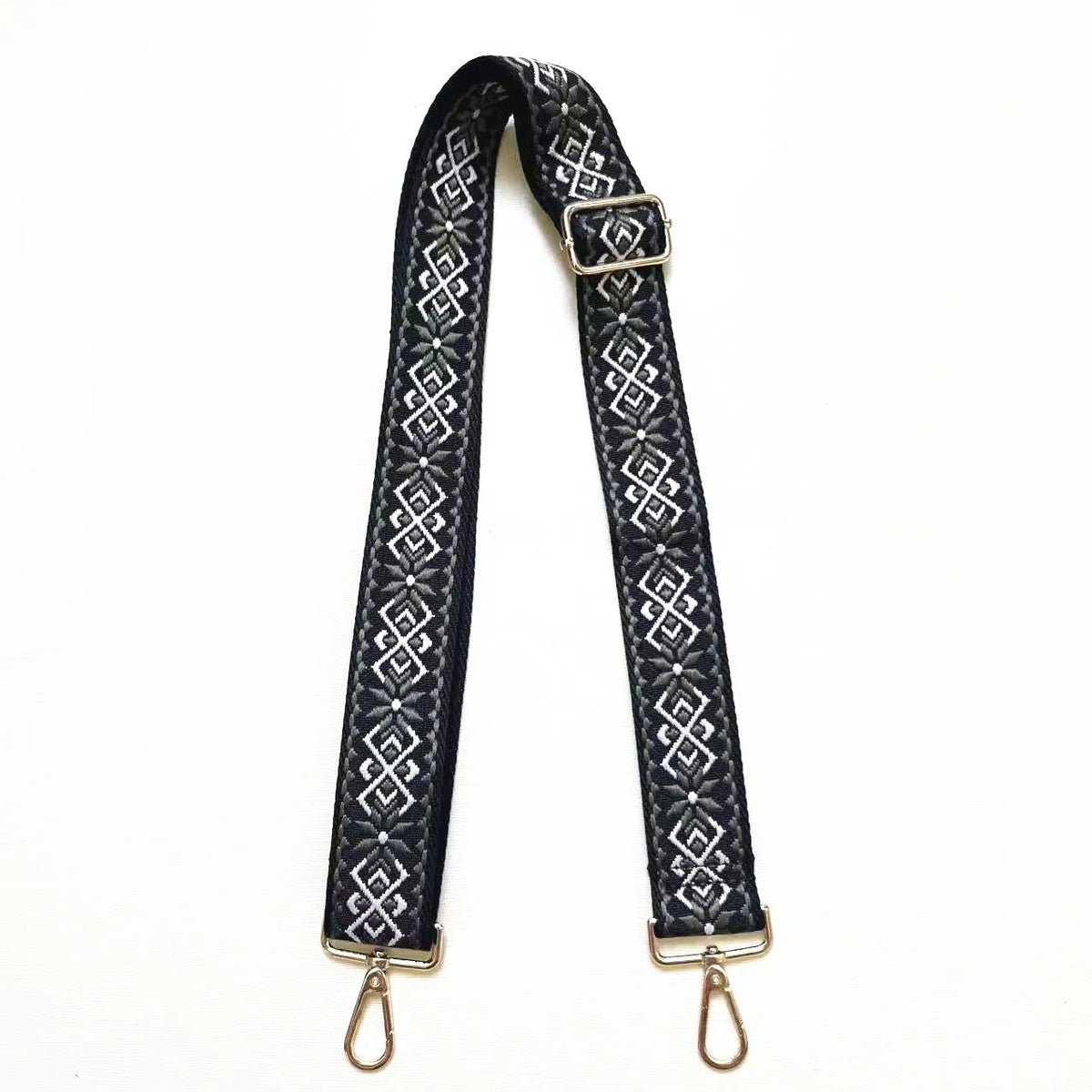 Black textile replacement bag strap with gold hardware and an intricate geometric pattern