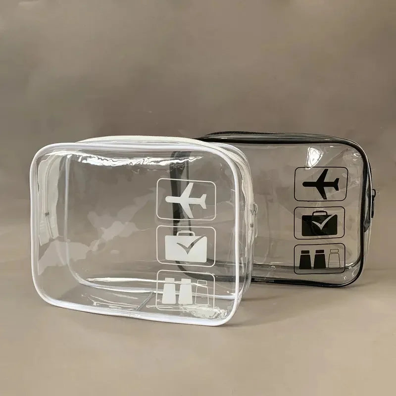 A clear plastic travel toiletry bag with black icons for various toiletries is shown on a neutral background.