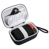 Open hard shell case for a digital camera with a padded interior and attached cable.