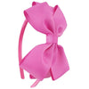 A pink satin bow headband is shown against a white background.