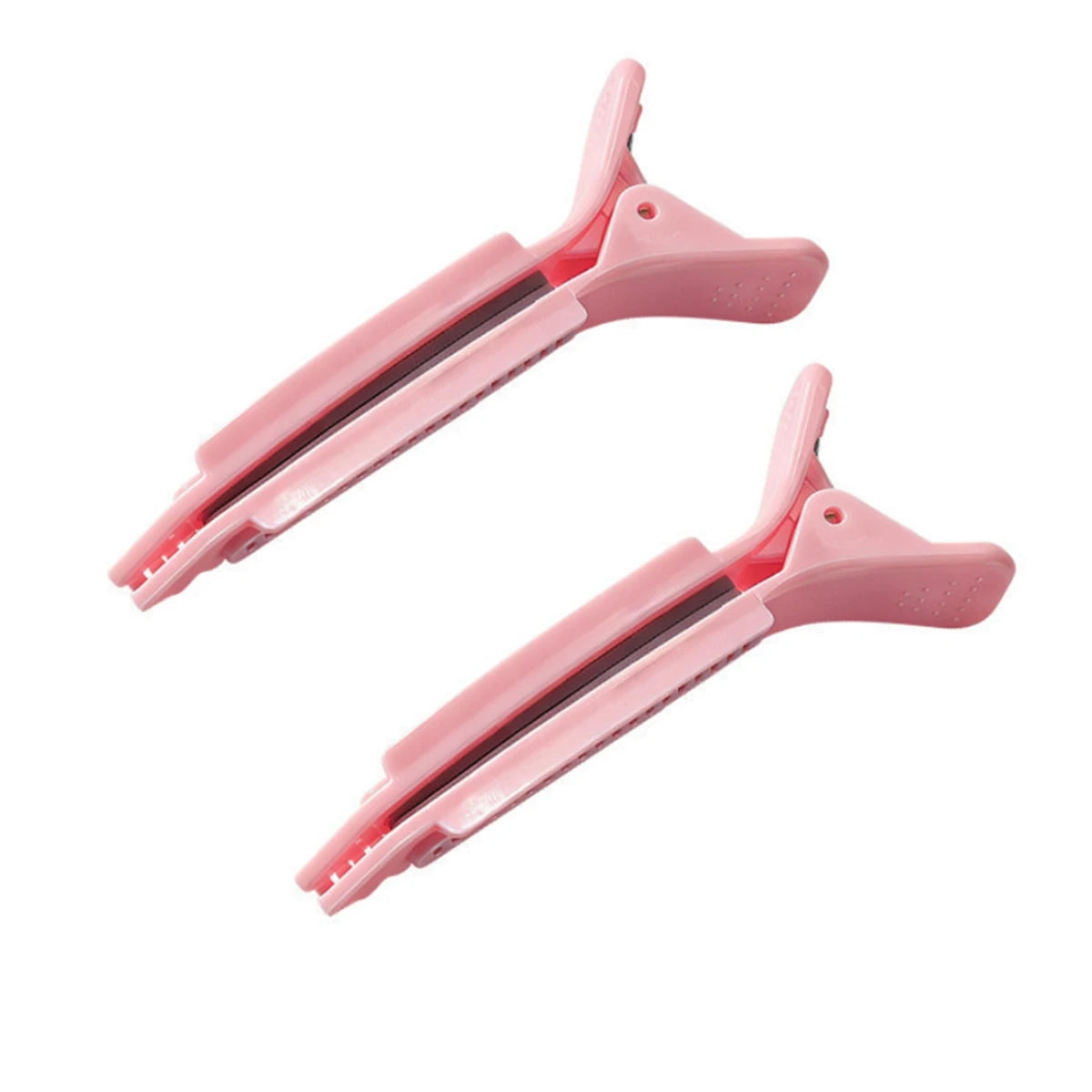Une paire de pinces à cheveux professionnelles roses antidérapantes pour le coiffage.