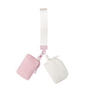 A mini nylon zip wristlet coin purse in pink and white with a white strap.