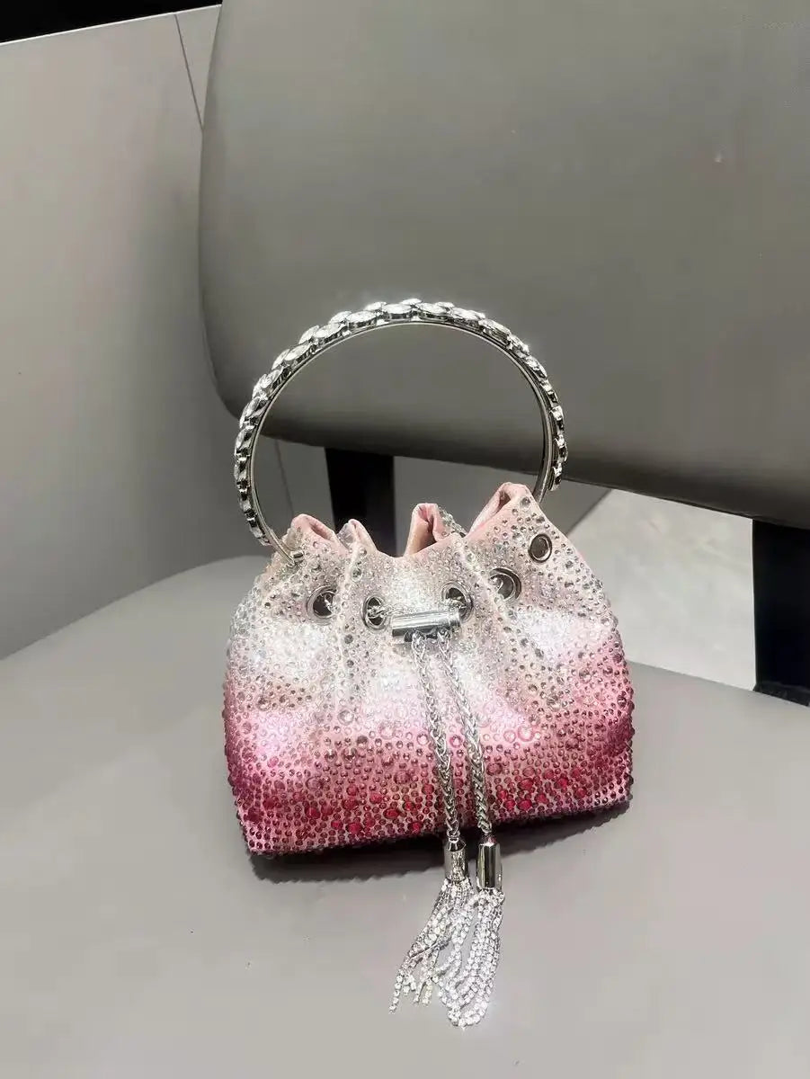 A pink and white crystal-embellished evening clutch with a silver chain and hoop.