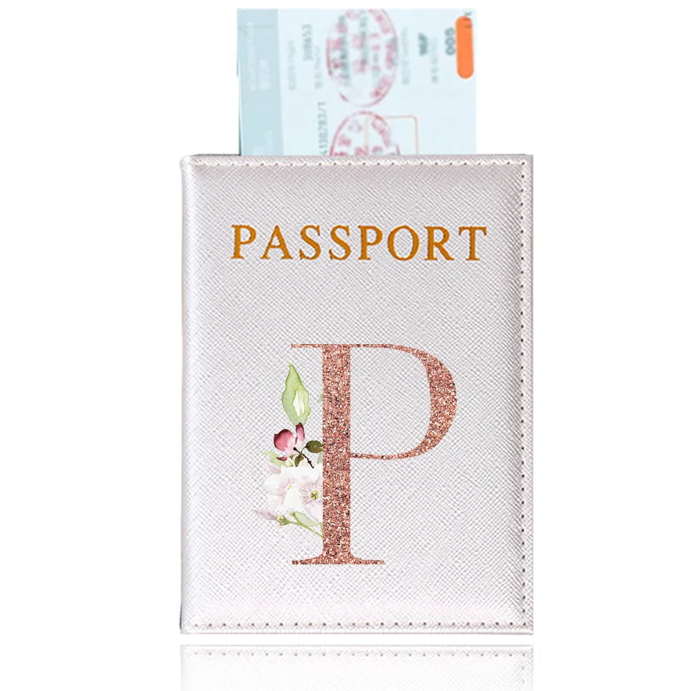 A pink leather passport holder with a gold embossed letter P and an ID card visible above it.