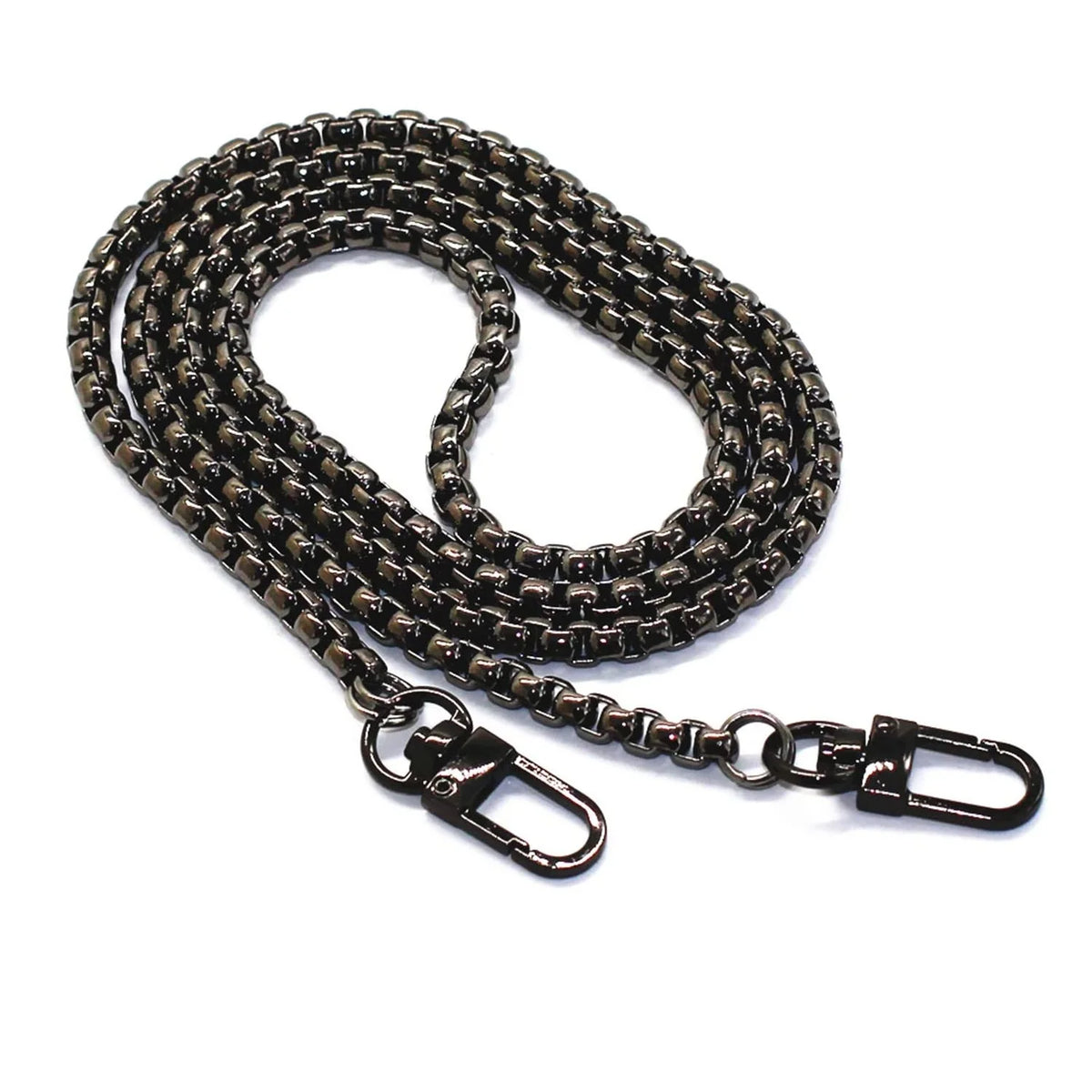 A close-up of a stainless steel diamond-cut curb chain bag strap with a dark finish.