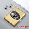 A gold card holder featuring an intricate skull design and two small diamond-encrusted clips.