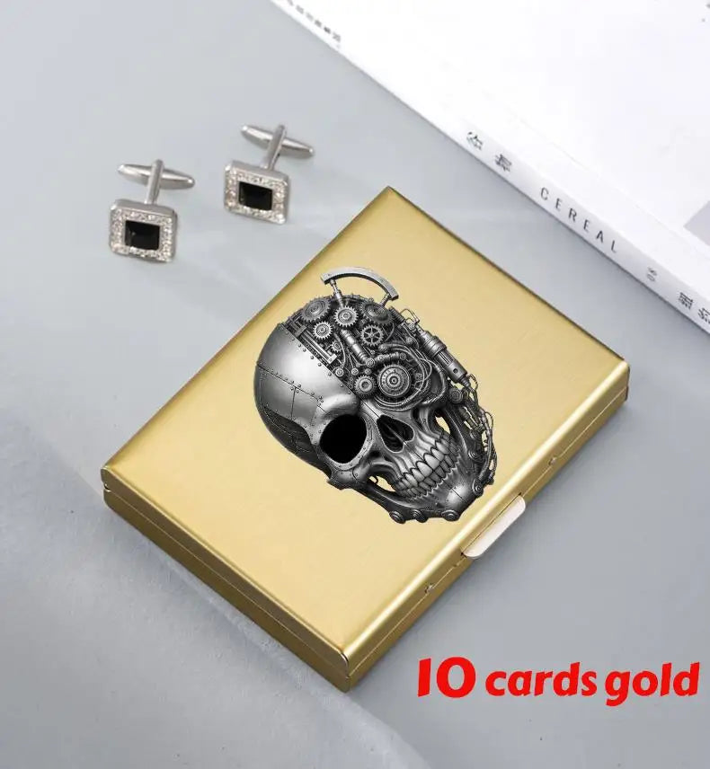 A gold card holder featuring an intricate skull design and two small diamond-encrusted clips.